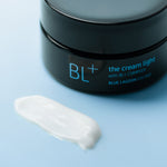 BL+ The Cream Light jar with cream texture on a light blue surface