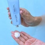 Model dispensing Mineral Mask into hand from tube