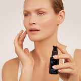Model holding BL+ Retinol Cream 0.3% while applying product to face