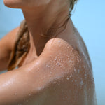 Texture of product on shoulder showing showing smooth texture and even absorption on the skin
