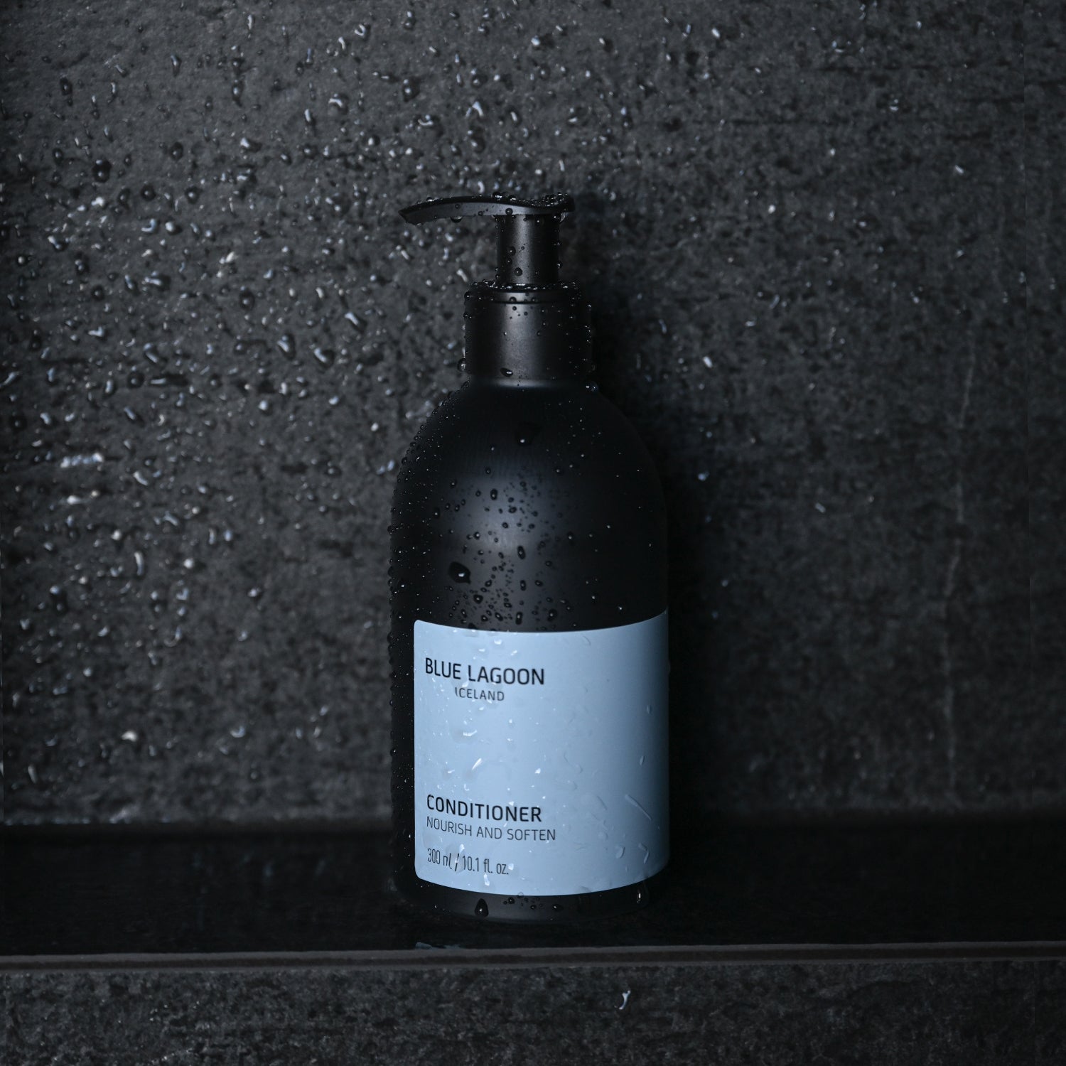 17oz Conditioner bottle standing on wet stone surface in shower setting