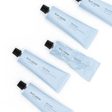 Hand Cream tubes arranged on white background, one tube partially squeezed