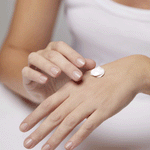 Person applying Hand Cream to the back of the hand