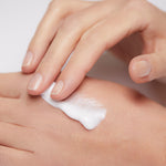 Model applying Mineral Moisturizing Cream on hand
