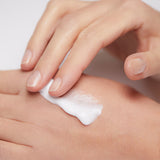 Model applying Mineral Moisturizing Cream on hand