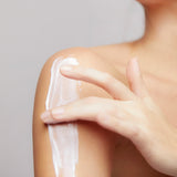 Model applying Mineral Moisturizing Cream on shoulder