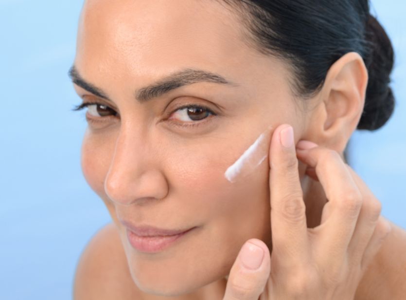 Model applying BL+ The Cream Light to the cheek