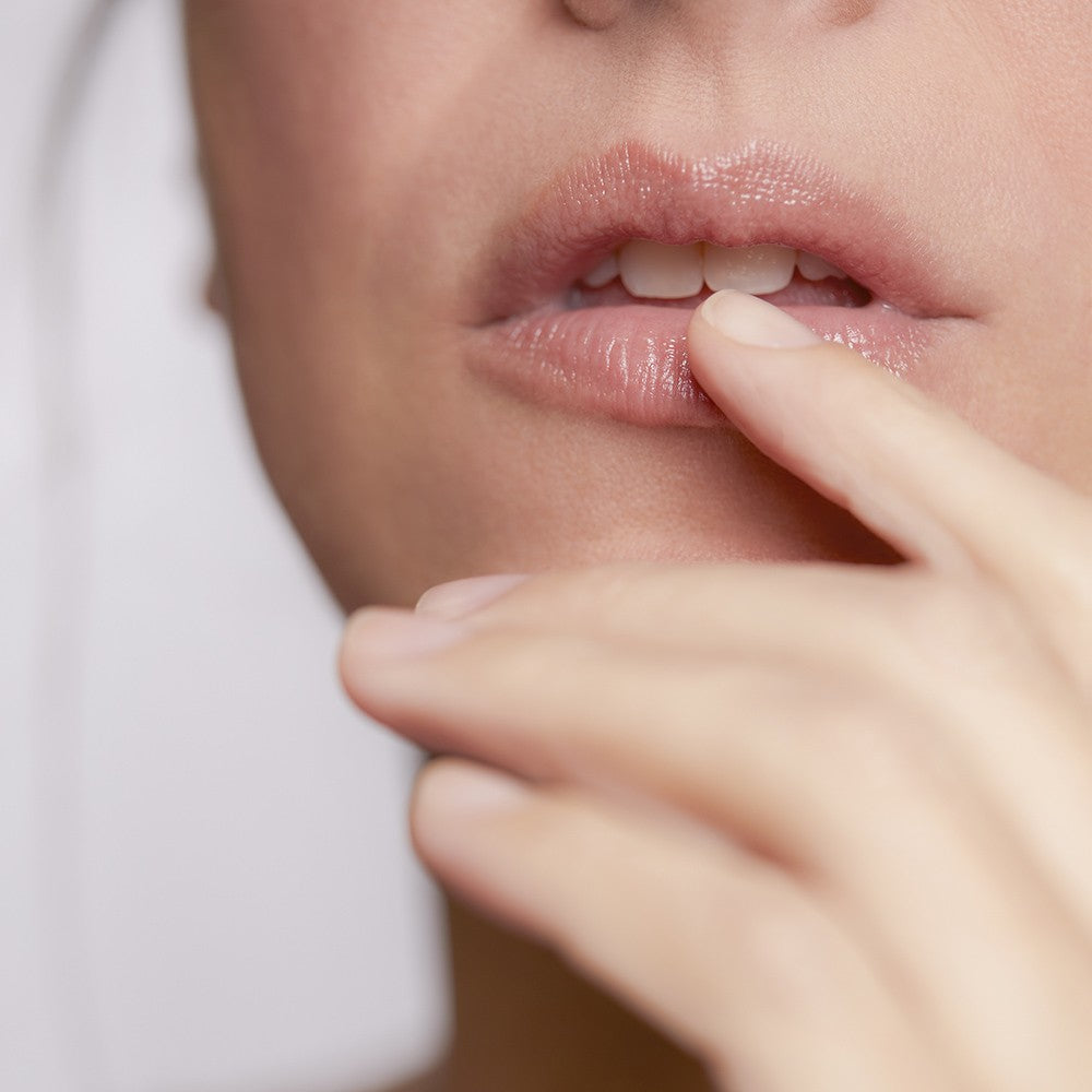 Close-up of model applying Lip Balm on