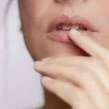 Close-up of model applying Lip Balm on